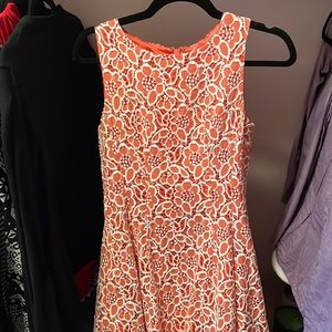 Coral dress with white lace.